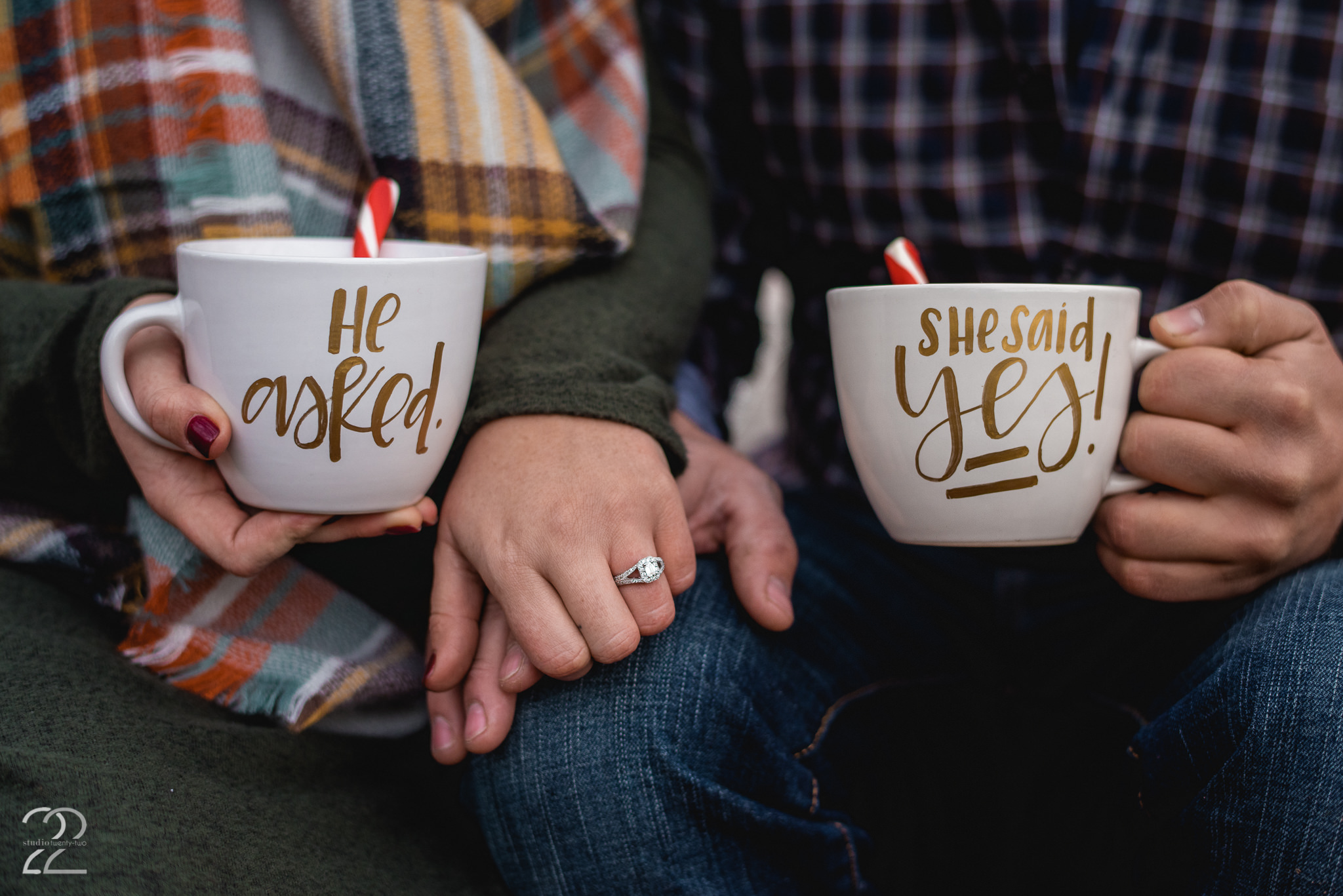 Close up of a man and woman holding hands, while both holding mugs that celebrate their new engagement in Dayton, Ohio by Dayton Wedding Photographer Studio 22 Photography